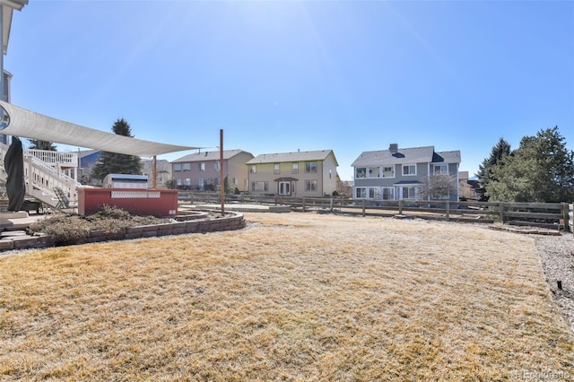 view of yard with fence and a residential view