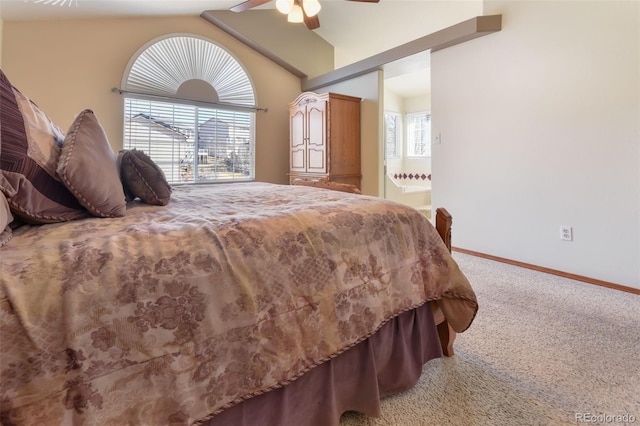 bedroom with lofted ceiling, connected bathroom, carpet flooring, baseboards, and ceiling fan