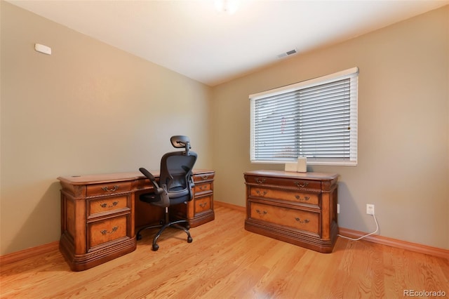 office featuring visible vents, baseboards, and light wood-style floors