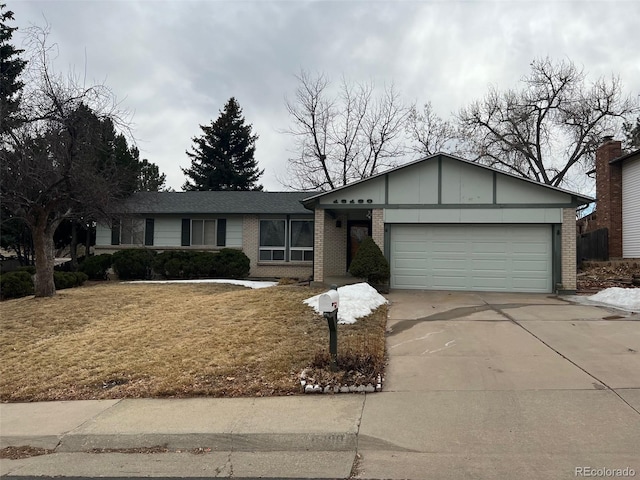 ranch-style home with a garage and a front lawn