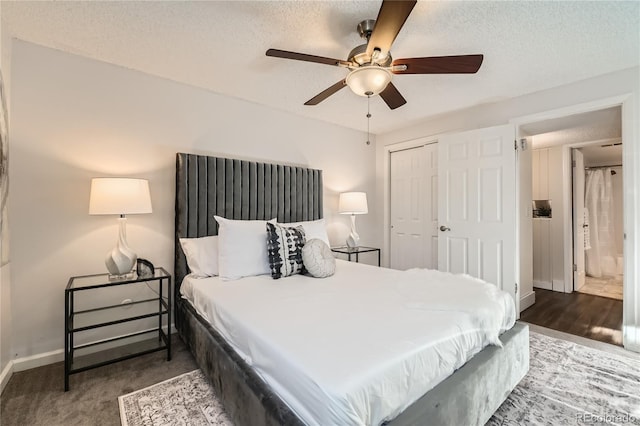 bedroom with dark colored carpet, a textured ceiling, ceiling fan, and a closet