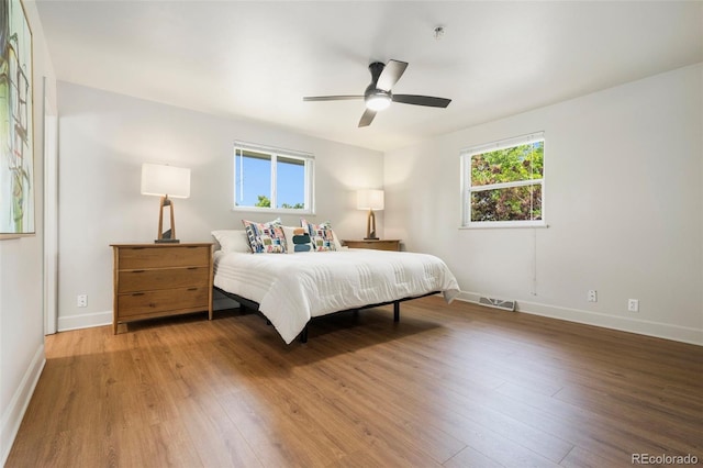 1420 W Ridge Rd, Littleton, CO 80120 - bedroom featuring multiple windows, wood finished floors, and baseboards