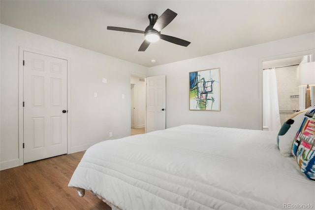 1420 W Ridge Rd, Littleton, CO 80120 - bedroom with wood finished floors, baseboards, a ceiling fan, and ensuite bath