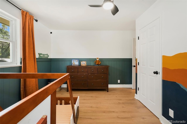 1420 W Ridge Rd, Littleton, CO 80120 - bedroom with wainscoting, light wood-style flooring, and a ceiling fan