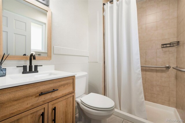 1420 W Ridge Rd, Littleton, CO 80120 - bathroom with toilet, vanity, and a shower stall