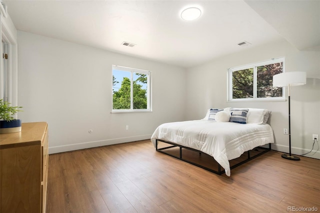 1420 W Ridge Rd, Littleton, CO 80120 - bedroom with multiple windows, wood finished floors, and baseboards