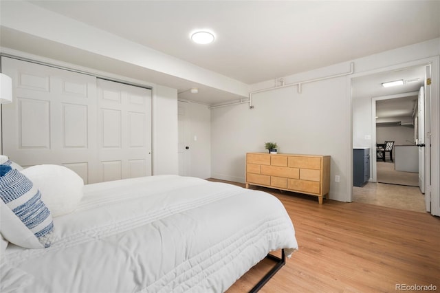 1420 W Ridge Rd, Littleton, CO 80120 - bedroom with light wood-style flooring and a closet
