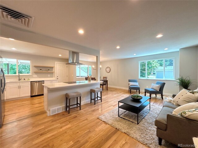6484 S Datura St, Littleton, CO 80120 - living room featuring plenty of natural light, recessed lighting, and light wood-style floors