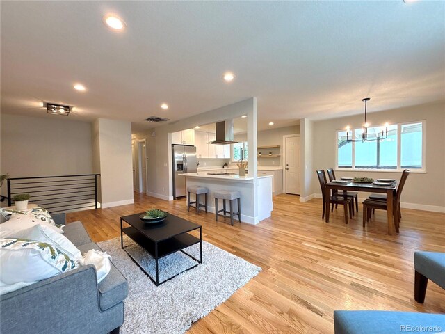 6484 S Datura St, Littleton, CO 80120 - living room featuring a chandelier, light wood-type flooring, and recessed lighting