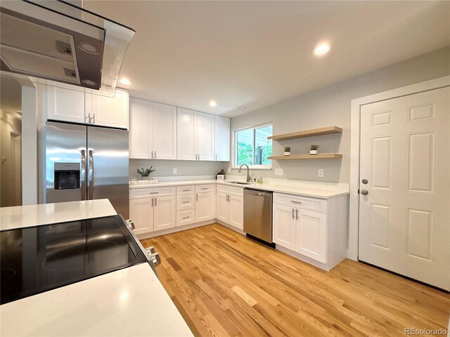 6484 S Datura St, Littleton, CO 80120 - kitchen featuring appliances with stainless steel finishes, white cabinetry, light countertops, light wood-type flooring, and recessed lighting