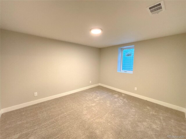 6484 S Datura St, Littleton, CO 80120 - spare room featuring baseboards and dark colored carpet