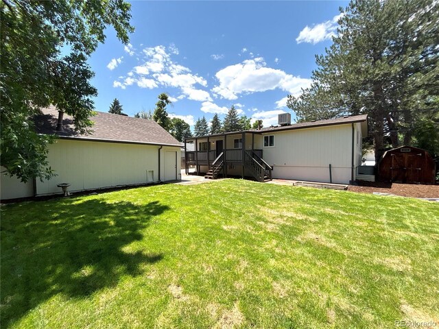 6484 S Datura St, Littleton, CO 80120 - back of property with a storage unit and a lawn