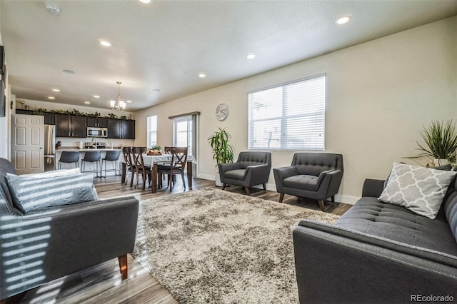13644 Ulster St, Thornton, CO 80602 - living area featuring recessed lighting, a chandelier, wood finished floors, and baseboards