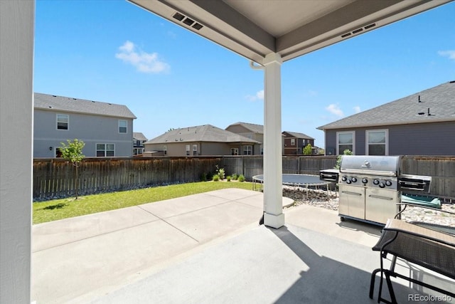 13644 Ulster St, Thornton, CO 80602 - view of patio / terrace with a residential view, a trampoline, and grilling area