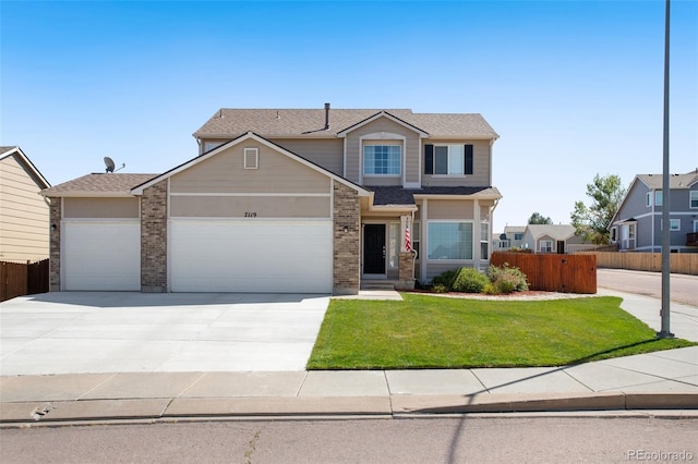 view of front of property featuring a garage and a front lawn