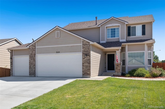 view of front facade with a garage and a front yard