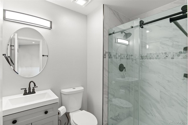 full bath featuring toilet, a shower stall, and vanity