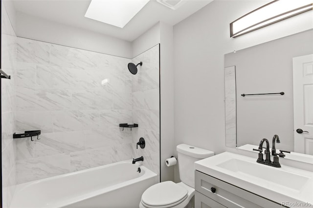 bathroom with a skylight, vanity, toilet, and bathing tub / shower combination