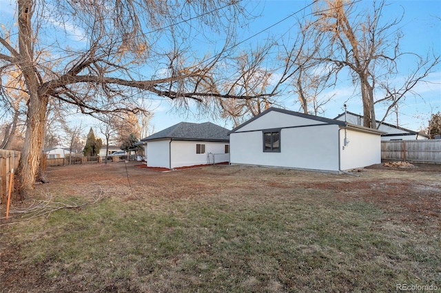 rear view of house with a lawn