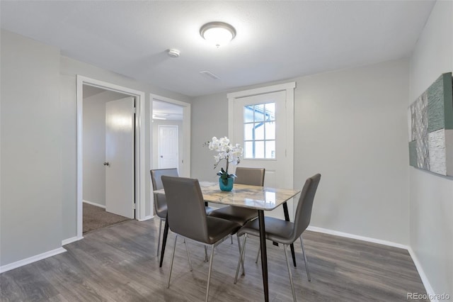 dining area featuring dark hardwood / wood-style flooring