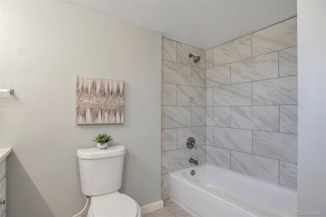 full bathroom featuring vanity, tiled shower / bath combo, and toilet