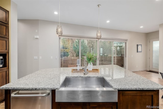 1848 W 68th Ave, Denver, CO 80221 - kitchen featuring a sink, light wood-style floors, plenty of natural light, light stone countertops, and recessed lighting