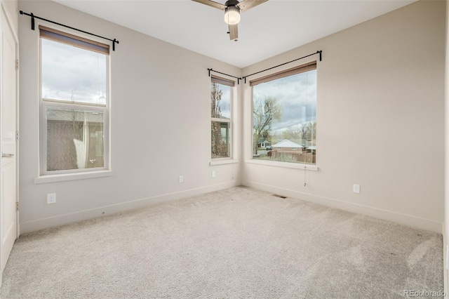 1848 W 68th Ave, Denver, CO 80221 - carpeted empty room with plenty of natural light, baseboards, and ceiling fan