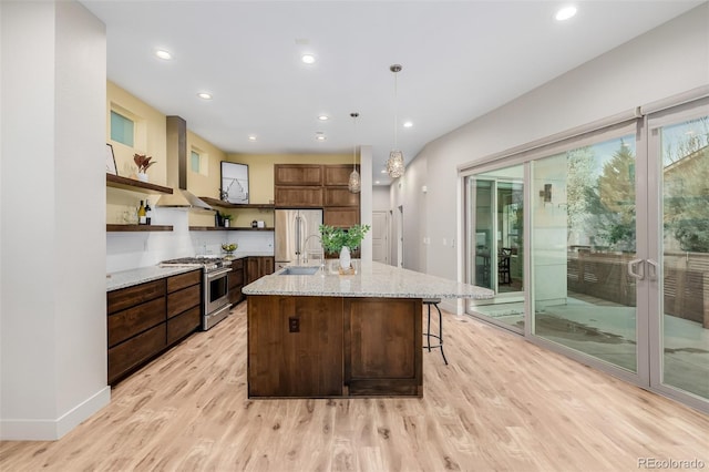 1848 W 68th Ave, Denver, CO 80221 - kitchen featuring appliances with stainless steel finishes, open shelves, light wood finished floors, a sink, and a kitchen island with sink
