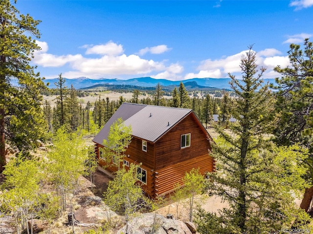 146 Atoka Dr, Como, CO 80432 - view of home's exterior featuring a mountain view, log siding, and a metal roof