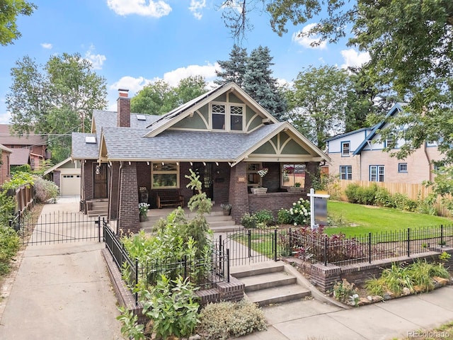 view of front of house featuring a garage, an outdoor structure, a porch, and a front yard