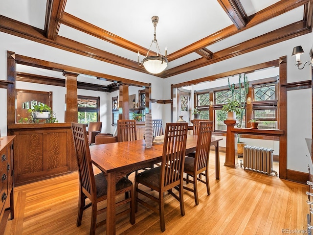 dining room with ornate columns, radiator heating unit, ornamental molding, coffered ceiling, and light hardwood / wood-style flooring