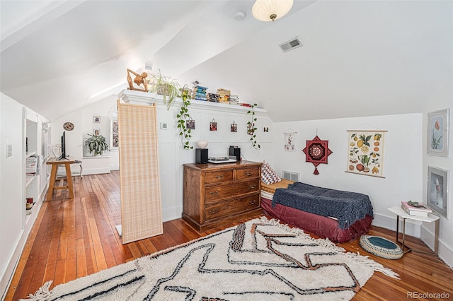 bedroom with vaulted ceiling and hardwood / wood-style floors