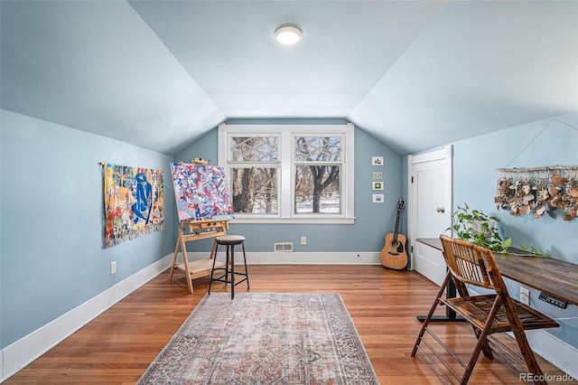 office space featuring lofted ceiling and hardwood / wood-style floors