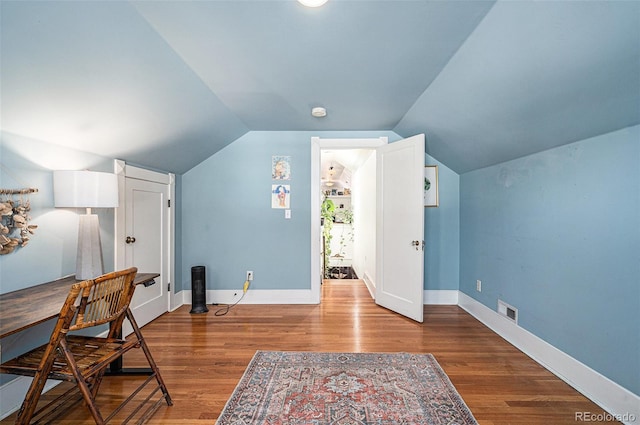 office space featuring hardwood / wood-style flooring and vaulted ceiling