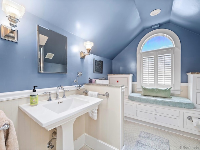 bathroom featuring lofted ceiling