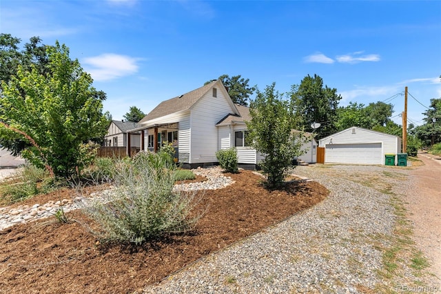 view of front of property with a porch, a garage, and an outdoor structure