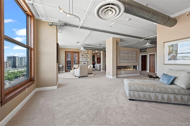 unfurnished living room featuring carpet floors, crown molding, and french doors