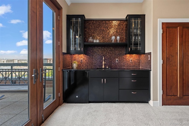 bar featuring backsplash, light colored carpet, french doors, dishwasher, and sink