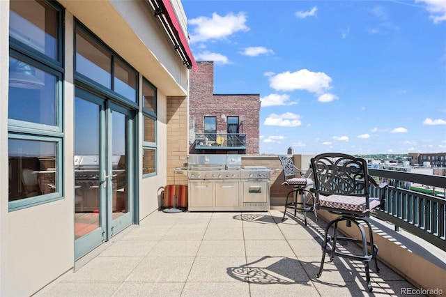 view of patio featuring a balcony and area for grilling