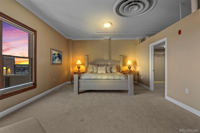 carpeted bedroom featuring a closet and a walk in closet