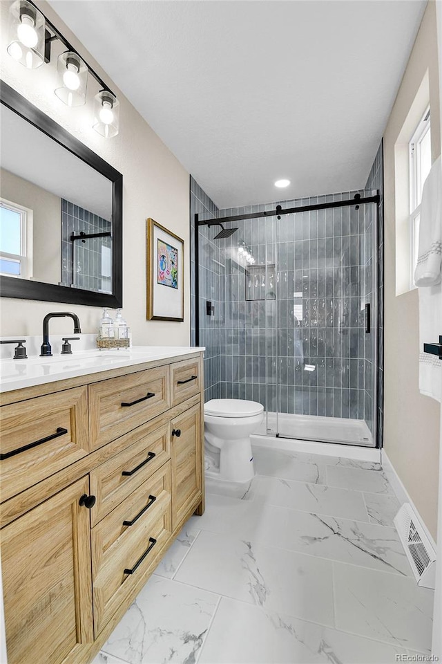 10431 Holland St, Broomfield, CO 80021 - bathroom with marble finish floors, a stall shower, toilet, and vanity