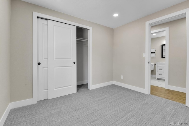 10431 Holland St, Broomfield, CO 80021 - unfurnished bedroom featuring carpet, a closet, baseboards, and recessed lighting