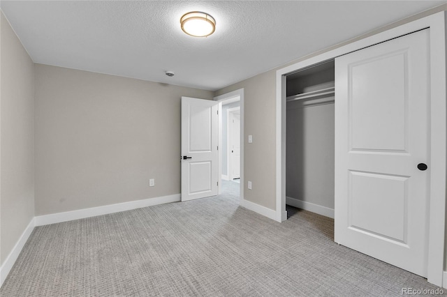 10431 Holland St, Broomfield, CO 80021 - unfurnished bedroom featuring a textured ceiling, a closet, baseboards, and light carpet