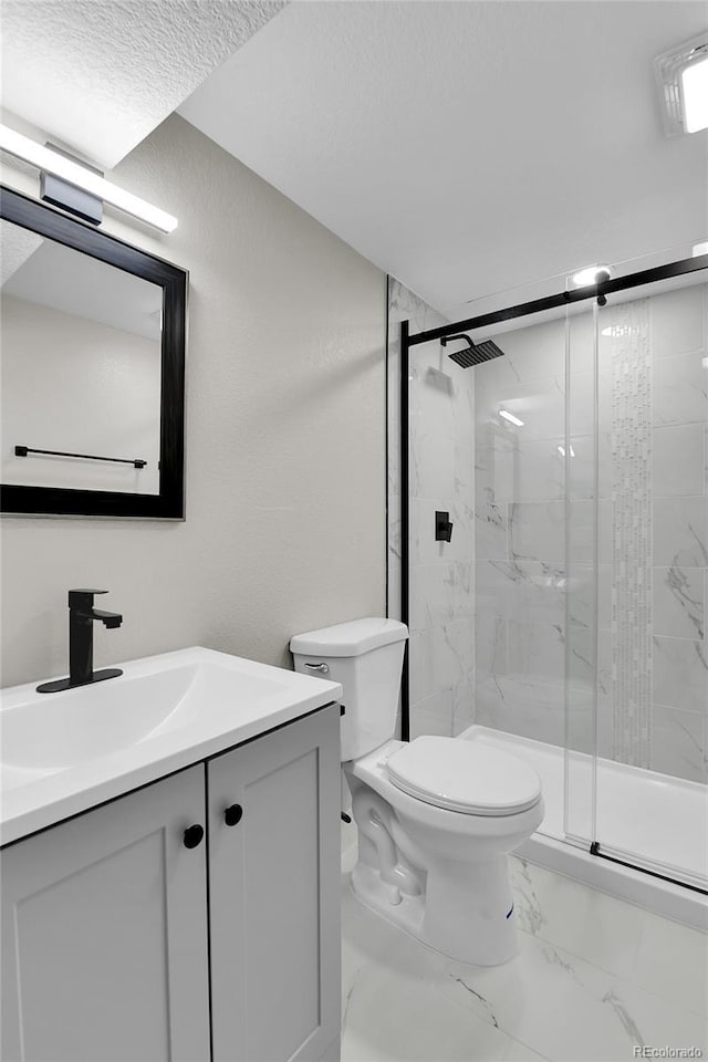 10431 Holland St, Broomfield, CO 80021 - full bathroom featuring toilet, a marble finish shower, vanity, and marble look tiles