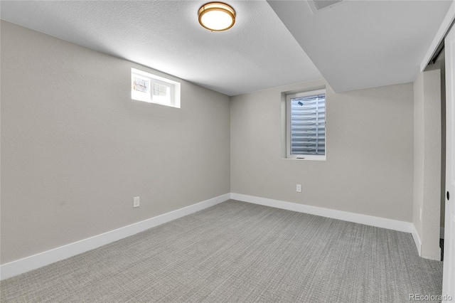 10431 Holland St, Broomfield, CO 80021 - below grade area featuring baseboards, carpet, and a textured ceiling