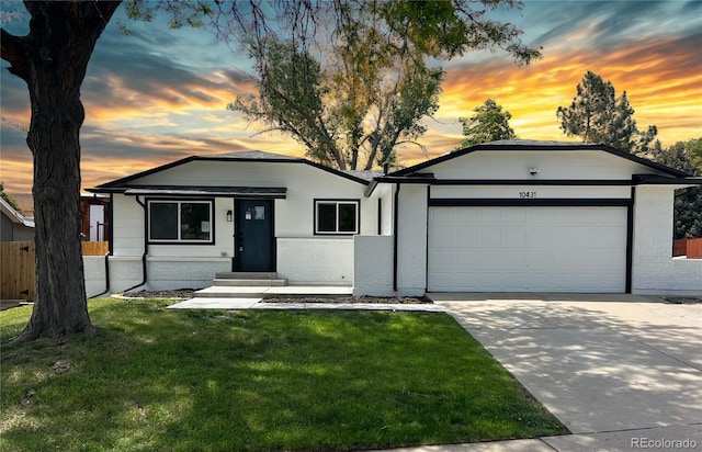 10431 Holland St, Broomfield, CO 80021 - single story home featuring brick siding, an attached garage, driveway, and entry steps