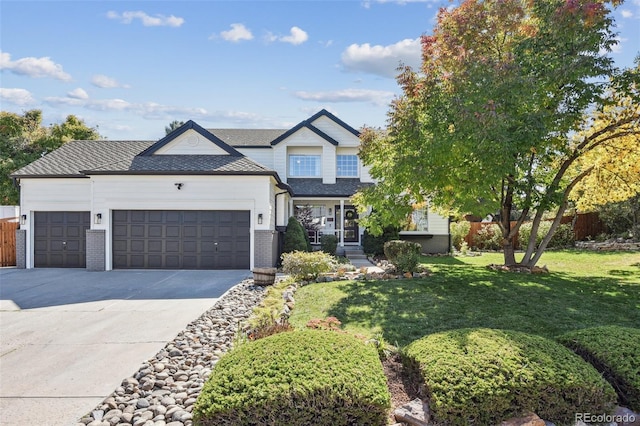 view of front of house featuring a front lawn and a garage