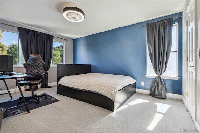 carpeted bedroom featuring a textured ceiling