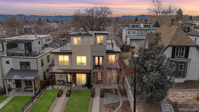 exterior space with stucco siding, a mountain view, a balcony, and a residential view