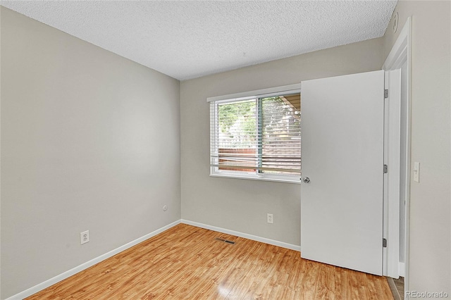 3890 S Atchison Way Unit B, Aurora, CO 80014 - spare room with wood finished floors and a textured ceiling
